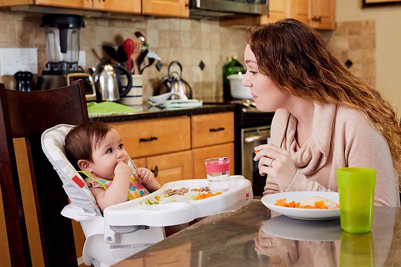 mom pointing to food on a plate